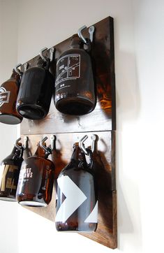 a wooden shelf with several bottles hanging on it