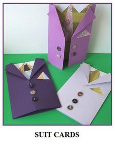 an origami suit card and some other items on a green surface with the words cut cards written below it