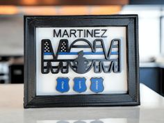 a black frame with blue and white police emblems on the front is sitting on a table