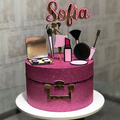 there is a pink cake that has makeup on it and the name sefia