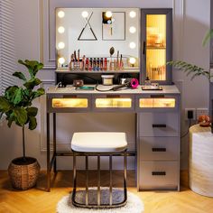 a vanity with lights on it and a stool in front of the mirror that is lit up