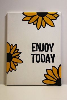 a white box with yellow and black flowers on it that says enjoy today in the center