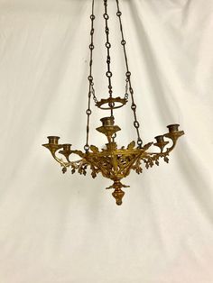 an antique chandelier hanging from a chain