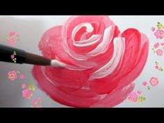 someone is painting a flower with pink and white paint