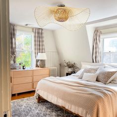 a bedroom with a bed, dresser and window