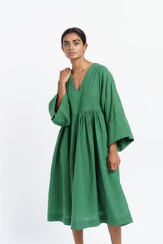 Oversized midi dress in mood elevating basil green color is tailored from handwoven cotton fabric by women artisans of India's western region. Designed for year-round utility, finished with subtle gathers at the waist to give the boxy fit additional contour. This dress would be ideal for transition weather and semi-formal settings. Oversized fit Softy gathered around the waist Roll-up long sleeves V-shaped neckline Dress length: 45 inches Roomy side pockets Lined with soft cotton fabric Model is Western Region, Handwoven Fabric, Necklines For Dresses, Organic Cotton Fabric, Women Artisans, Independent Designers Fashion, Dressed Down, Nordstrom Dresses, Xl Dress