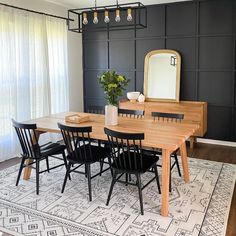 a dining room table and chairs with a rug on the floor in front of it