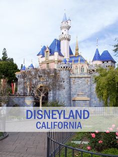 the disneyland and california sign is in front of a castle with turrets on it's roof