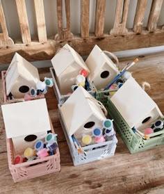 several boxes filled with different types of crafting supplies on top of a wooden table