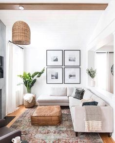 a living room filled with furniture and pictures on the wall