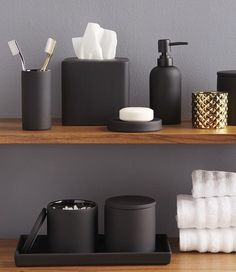 black and white bathroom accessories on wooden shelves