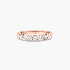 a rose gold wedding band with five diamonds