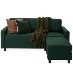 a green couch with pillows on it and a blanket draped over the armrests