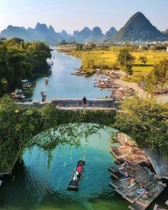 boats are floating on the water near mountains