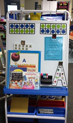 a white and blue cart with lots of school supplies on it's sides in a classroom