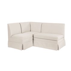 a white sectional couch with two pillows on it's back and the seat folded down