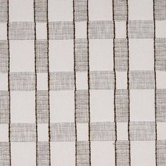 a white and brown checkered wallpaper with vertical lines on the bottom half of it