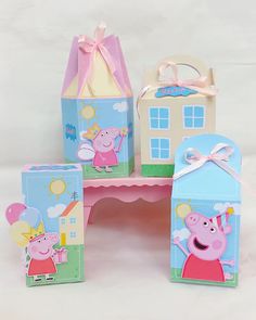 three peppa pig boxes sitting on top of a pink table