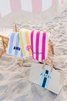 two beach towels sitting on top of a wooden chair next to a sign that says amd