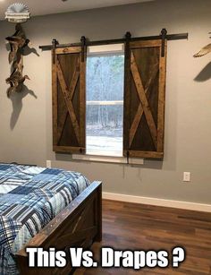 a bedroom with a bed and two wooden barn doors on the wall above it's headboard