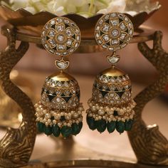 Description Inspired by the opulence of Indian heritage, this regal floral Jhumki is a jewellery essential. An intricate jhumki with floral nuances drop from a distinctive blossom. The deep green enamel detailing reflects the imperial colour of green droplets encircled by light yellow pearls. This magnificent piece stands proudly as testimony to the mastery of artisans. Product Information Metal: 925 Silver with 1.0 microns Gold Plating Length: 7.5 cm Stones: Semi precious jadau Findings: Thread Luxury Party Jhumkas With Meenakari, Luxury Latkan Pearl Earrings For Festive Occasions, Luxury Diamond Meenakari Earrings, Luxury Designer Jhumkas For Diwali, Luxury Meenakari Temple Jewelry Chandelier Earrings, Luxury Chandbalis Drop Earrings For Celebration, Luxury Heavy Jhumkas For Diwali, Luxury Intricate Jhumkas For Formal Occasions, Luxury Kundan Meenakari Chandelier Earrings