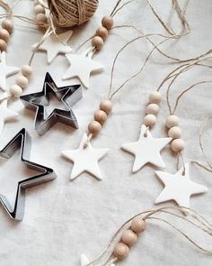 three star shaped cookie cutters sitting on top of a table next to some string