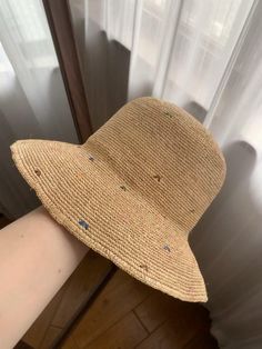 This hat is based on raffia straw, and the overall design is fresh and natural, suitable for daily wear. The hat is made of light straw, which is breathable and suitable for summer use. It is both practical and fashionable. Its wide brim provides good sun protection and can effectively block strong sunlight. At the same time, the edge of the brim has a slight wave feeling, adding a soft temperament. The surface of the hat is dotted with some colorful embroidery patterns, which adds fun and perso Casual Brown Straw Hat, Natural Woven Straw Bucket Hat, Natural Woven Bucket Hat With Short Brim, Natural Straw Bucket Hat With Curved Brim, Natural Curved Brim Straw Bucket Hat, Summer Woven Bucket Hat With Short Brim, Spring Straw Hat In Natural Fiber, Summer Woven Bucket Hat, Multicolor Bucket Straw Hat For Spring