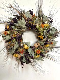 a wreath made out of dried flowers and leaves