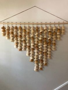 a bunch of wooden objects hanging on a wall