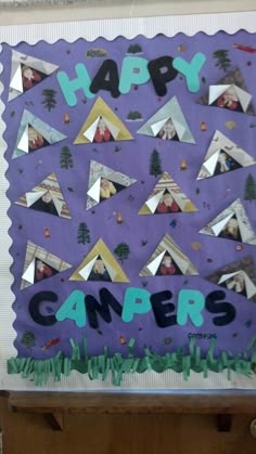 a purple cake with the words happy campers on it and pictures of people in tents