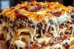 a close up of a piece of food with cheese and other toppings on it