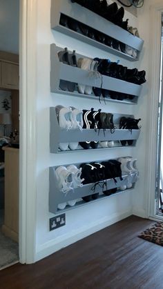 there are many pairs of shoes hanging on the wall