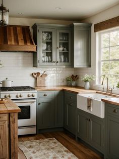 a kitchen with green cabinets and white appliances