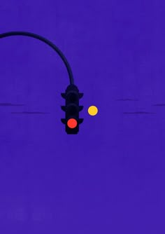 a traffic light on a purple background with yellow and orange balls in the sky behind it