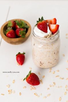 a jar filled with oatmeal and topped with strawberries