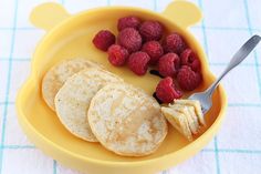 raspberries and pita bread in a yellow bowl on a blue tablecloth