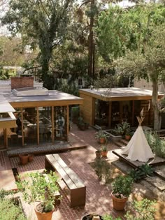 an aerial view of a patio with potted plants and trees in the back ground