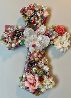 a cross made out of beads and flowers