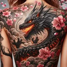 the back of a woman's body with flowers and a dragon tattoo on it