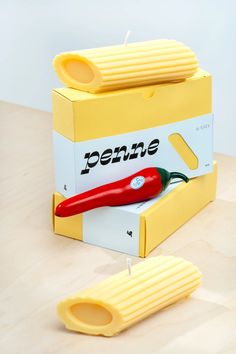 a pair of scissors sitting on top of a yellow box next to a red handle