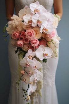 a bride holding a bouquet of pink and white flowers