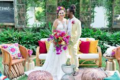 a bride and groom standing in front of some chairs