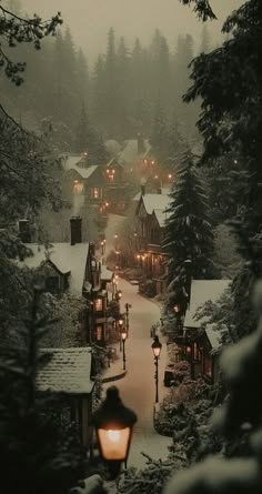 a person walking down a snow covered road at night