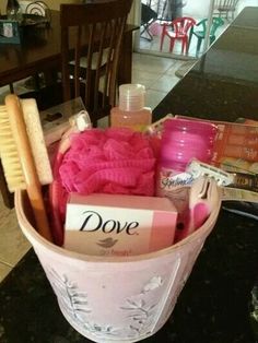 a pink basket filled with items on top of a table