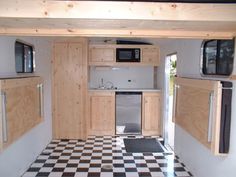 the inside of a tiny home with black and white checkered flooring on the walls