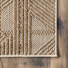 a close up of a rug on a wooden floor with wood floors in the background