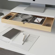 an apple computer sitting on top of a white desk