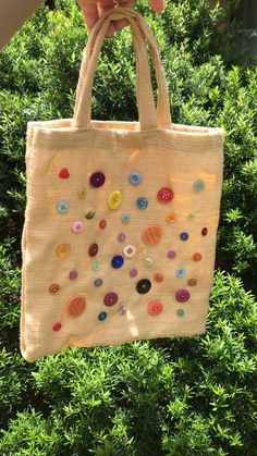 a hand holding a bag with buttons on it