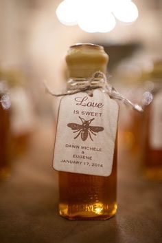 honey bottles with labels on them sitting on a table