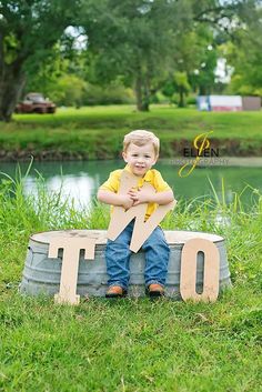 a little boy sitting on top of a barrel with the word tio cut out